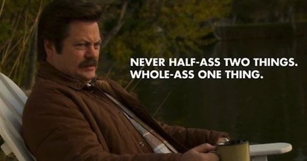 A man with a mustache sitting outdoors holding a mug, with the text "Never half-ass two things. Whole-ass one thing." displayed beside him.